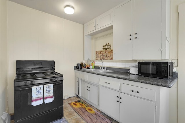 kitchen featuring tasteful backsplash, sink, white cabinets, and black appliances