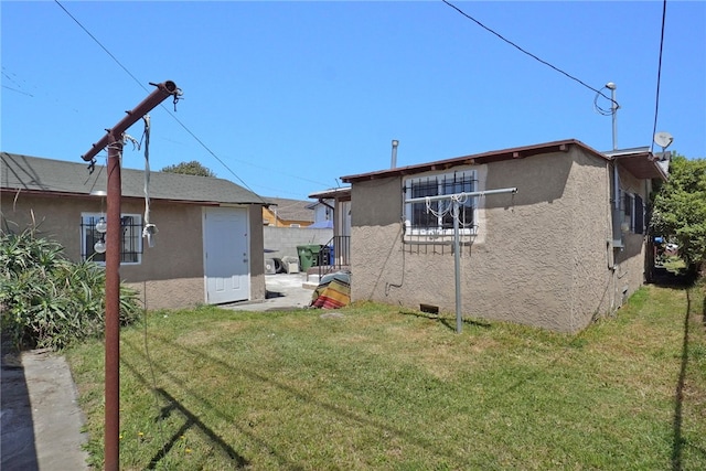 rear view of property with a lawn