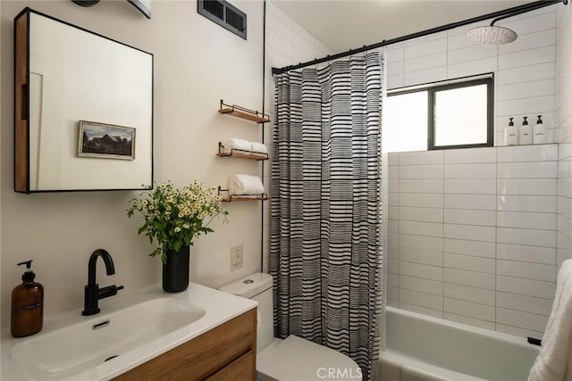 full bathroom with shower / tub combo, vanity, and toilet