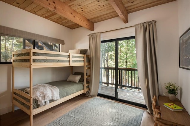 bedroom featuring hardwood / wood-style flooring, beam ceiling, wooden ceiling, and access to outside