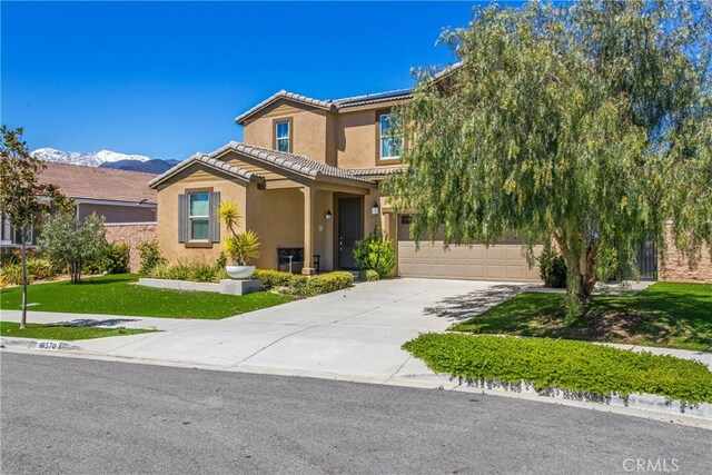 view of front of home featuring a garage and a front lawn