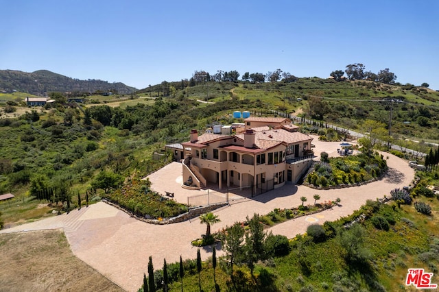 birds eye view of property featuring a mountain view