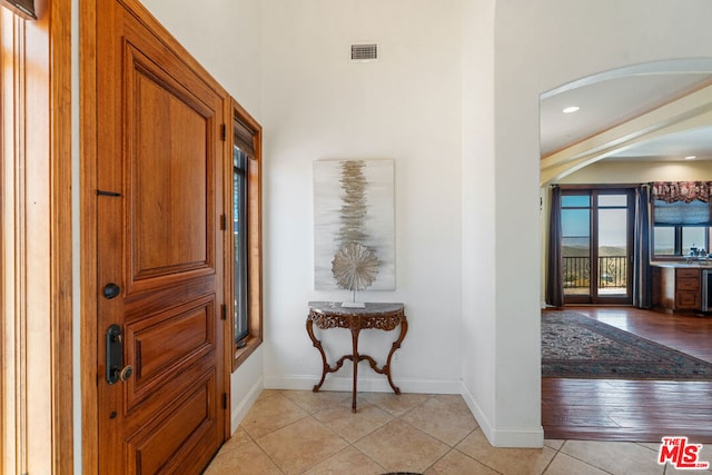 tiled entrance foyer featuring beverage cooler