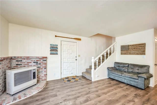 foyer with hardwood / wood-style flooring and heating unit