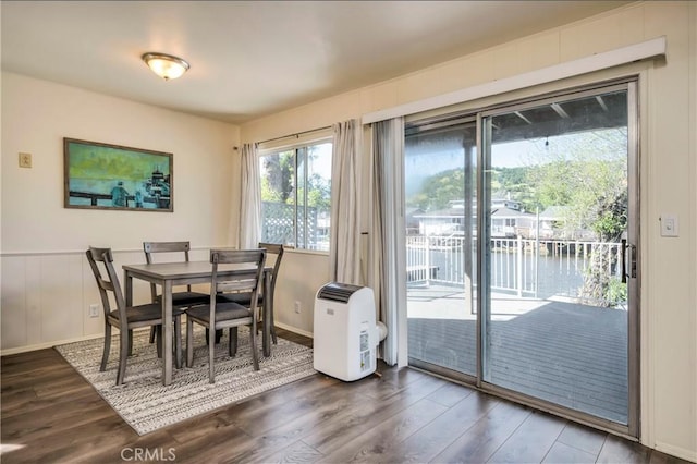 dining space featuring a water view and hardwood / wood-style floors