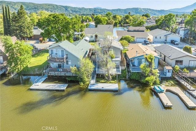 drone / aerial view with a water and mountain view