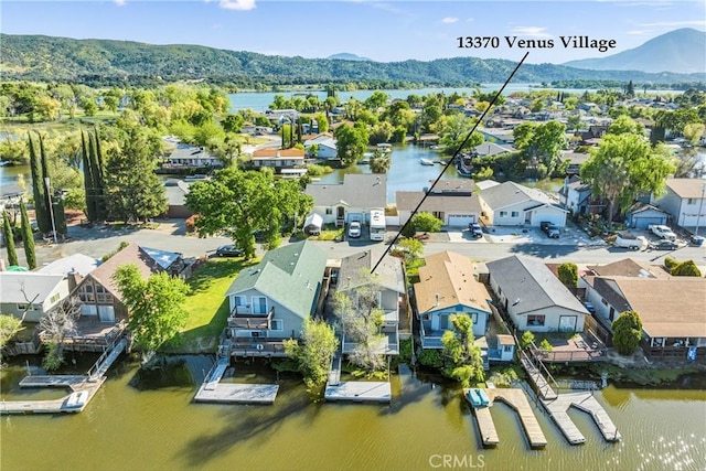 drone / aerial view featuring a water and mountain view