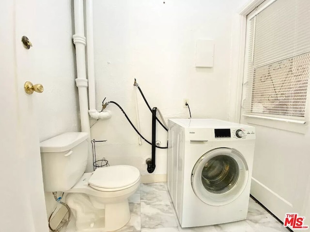 washroom featuring light tile flooring and washer / dryer