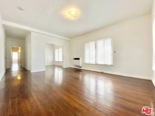 empty room featuring dark hardwood / wood-style flooring