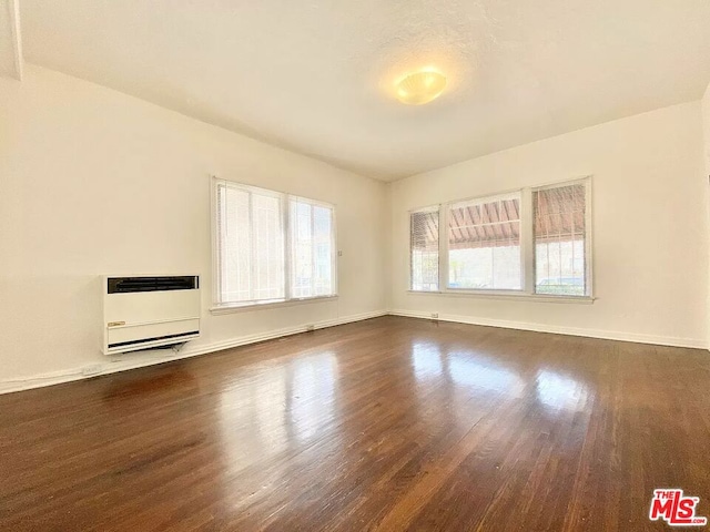 unfurnished room with dark hardwood / wood-style floors