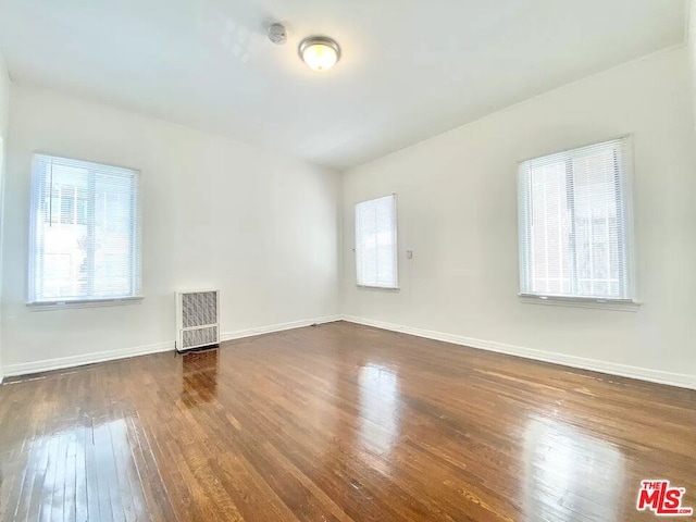 empty room featuring dark hardwood / wood-style flooring