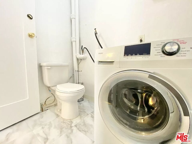 laundry area featuring washer / clothes dryer and light tile floors