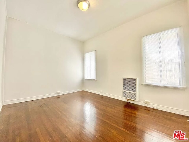 empty room with dark wood-type flooring