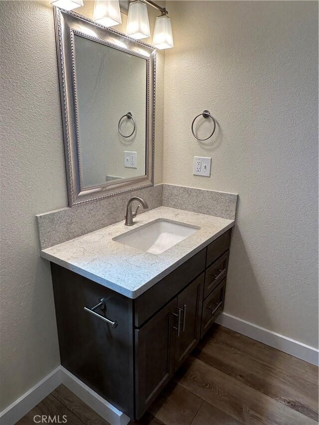 bathroom with vanity and hardwood / wood-style floors