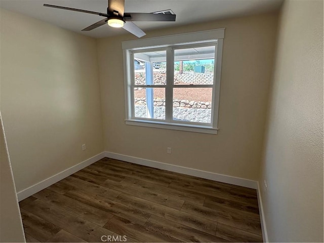 unfurnished room with ceiling fan and dark hardwood / wood-style flooring