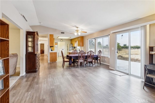 dining space featuring vaulted ceiling, hardwood / wood-style floors, and ceiling fan