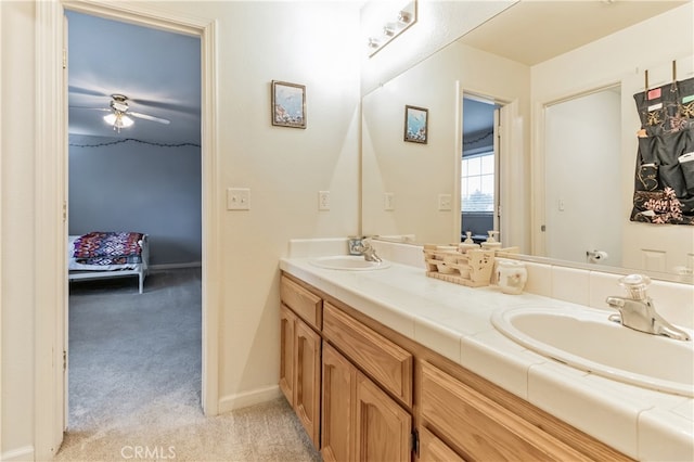 bathroom featuring ceiling fan and dual vanity