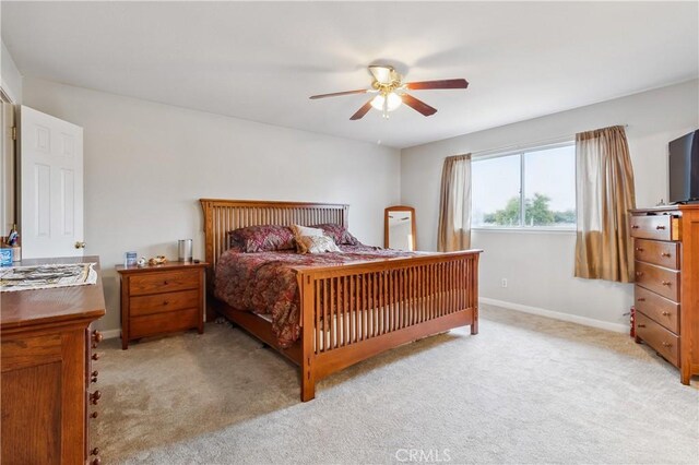 bedroom with light carpet and ceiling fan