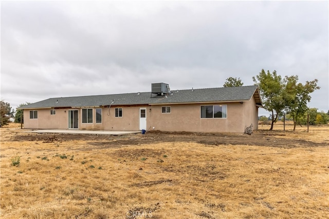 rear view of property featuring central AC