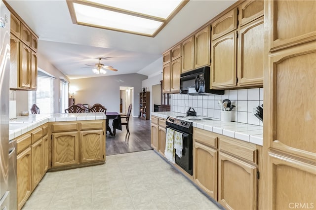 kitchen featuring ceiling fan, tile countertops, black appliances, and light tile flooring