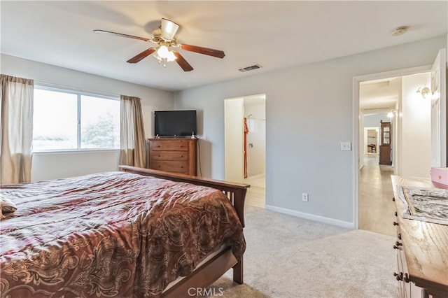 carpeted bedroom featuring ensuite bath and ceiling fan