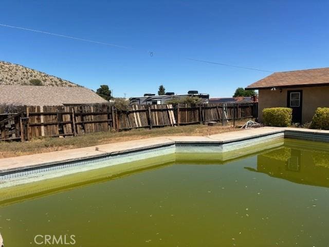view of swimming pool featuring a fenced in pool and a fenced backyard