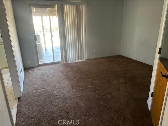spare room featuring a healthy amount of sunlight and carpet