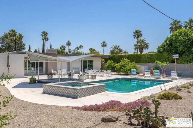 view of swimming pool with an in ground hot tub and a patio