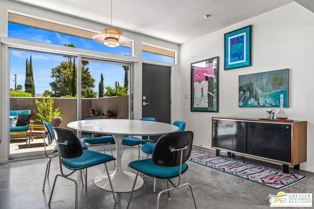 dining space featuring concrete floors