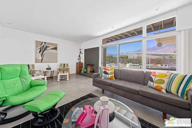 living room with a mountain view and concrete floors