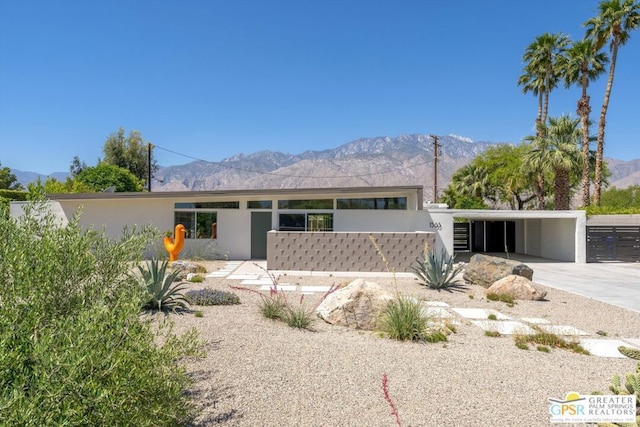 single story home featuring a mountain view and a carport