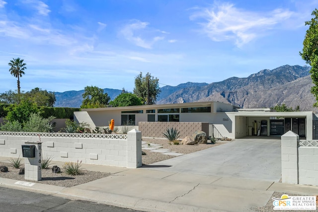 view of front facade featuring a carport and a mountain view