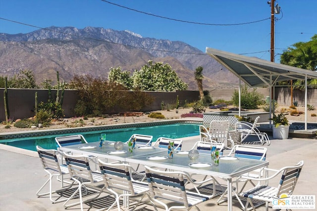 view of pool with a mountain view and a patio area