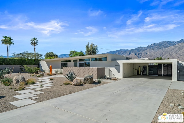 view of front of property with a mountain view and a carport