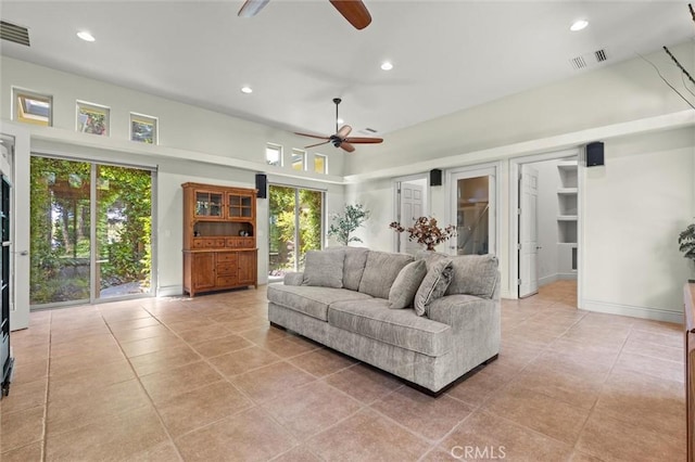 living room with a healthy amount of sunlight, visible vents, and recessed lighting