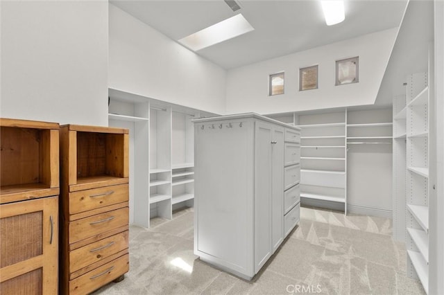 walk in closet with light carpet and a skylight