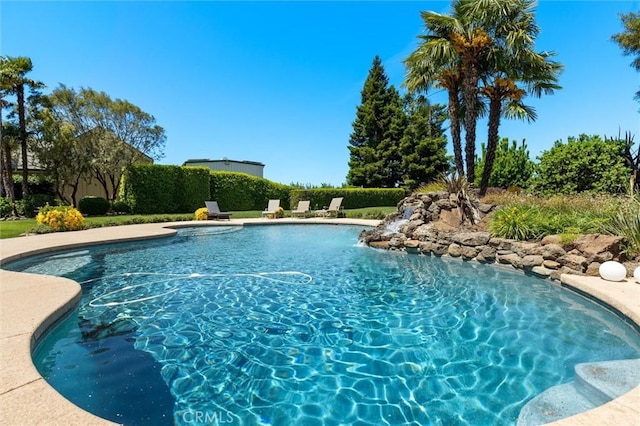 view of swimming pool with a fenced in pool