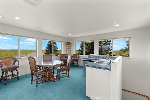 dining room featuring recessed lighting, baseboards, and light colored carpet