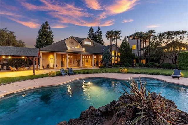 pool featuring a yard and a patio area