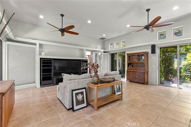 living room with light tile patterned floors, ceiling fan, visible vents, and recessed lighting