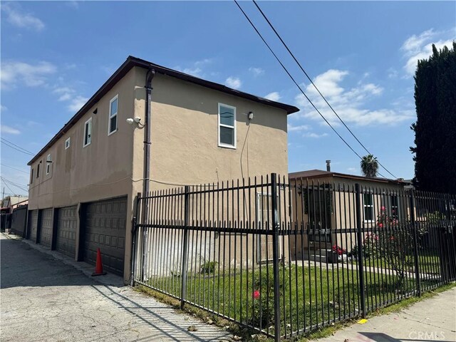 view of property exterior with a yard and a garage