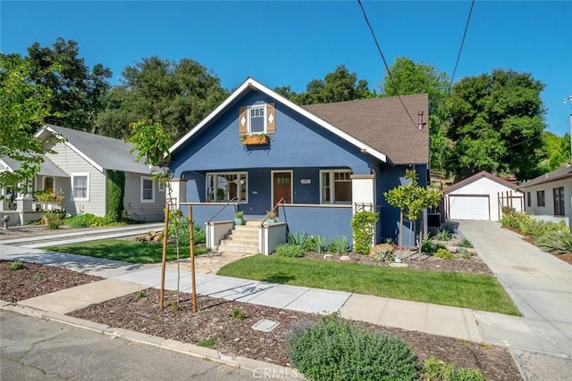 bungalow featuring covered porch, a garage, and an outdoor structure