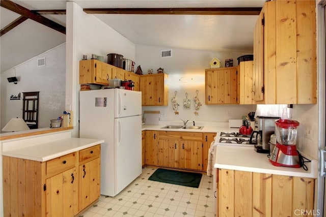 kitchen featuring lofted ceiling, white appliances, and sink