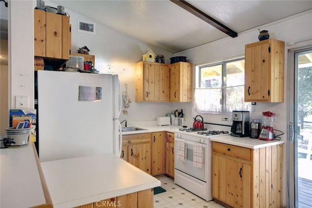 kitchen with white appliances, sink, and light brown cabinetry