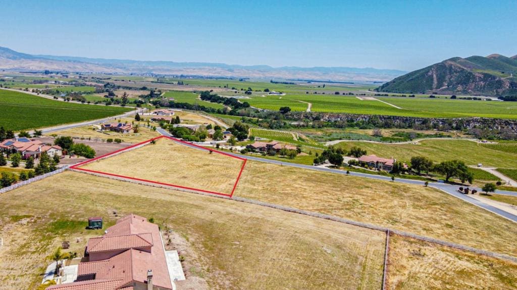 drone / aerial view featuring a rural view and a mountain view