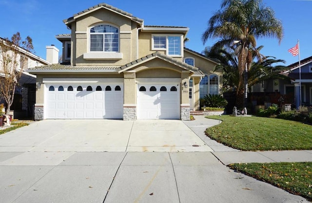 view of front of house with a garage and a front yard