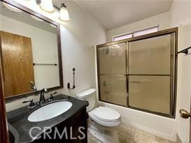 full bathroom featuring bath / shower combo with glass door, vanity, and toilet