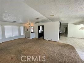 unfurnished living room featuring light tile patterned floors