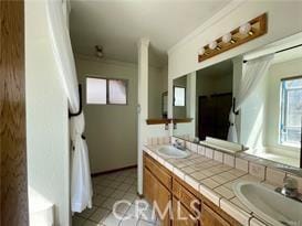 bathroom with vanity and tile patterned flooring