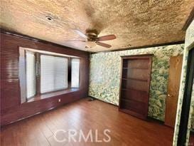 unfurnished room with hardwood / wood-style floors and ceiling fan